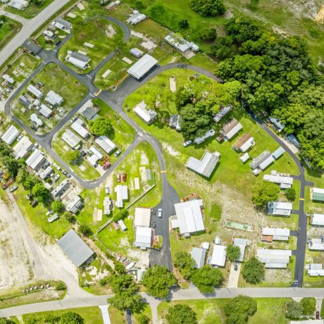 A wide-angle view of Lake Letta RV Park, showcasing the homes and beautifully landscaped surroundings in the 55+ community of Avon Park, FL.