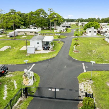 A wide-angle view of Lake Letta RV Park, showcasing the homes and beautifully landscaped surroundings in the 55+ community of Avon Park, FL.