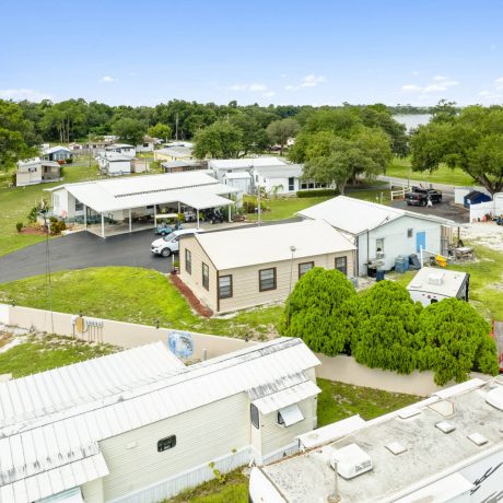 The exterior of a tropical-style clubhouse where seniors can enjoy activities and events at Lake Letta RV Park in Avon Park, FL.