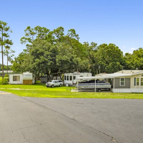 The exterior of a tropical-style clubhouse where seniors can enjoy activities and events at Lake Letta RV Park in Avon Park, FL.